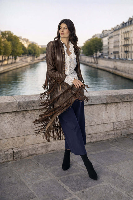 DIAMOND giacca lunga in pelle con frange, indossata da una donna in riva al fiume a Parigi.